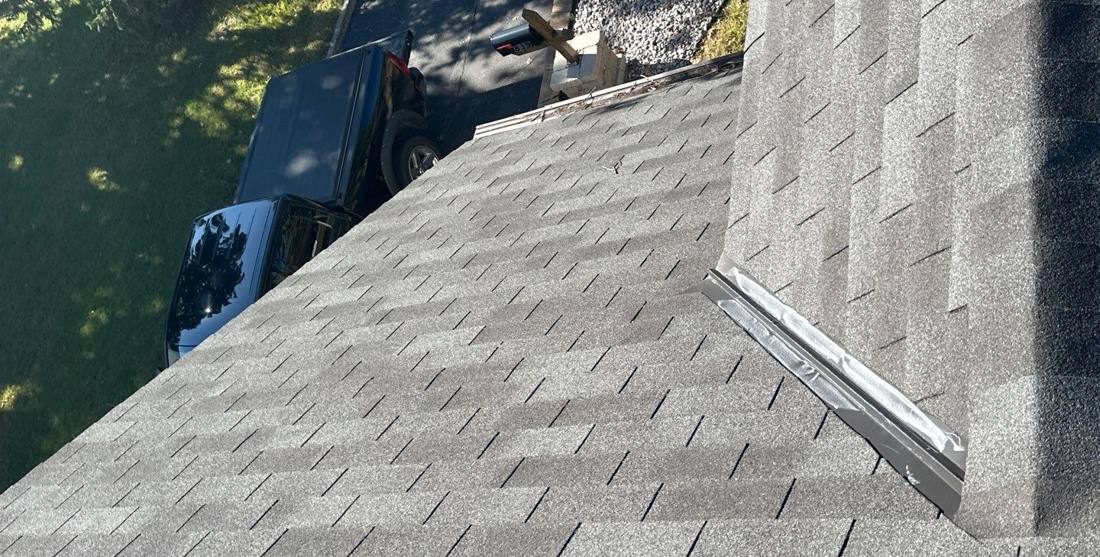 Close-up of chalk-marked hail hits on asphalt shingles in New Brighton, June 2025