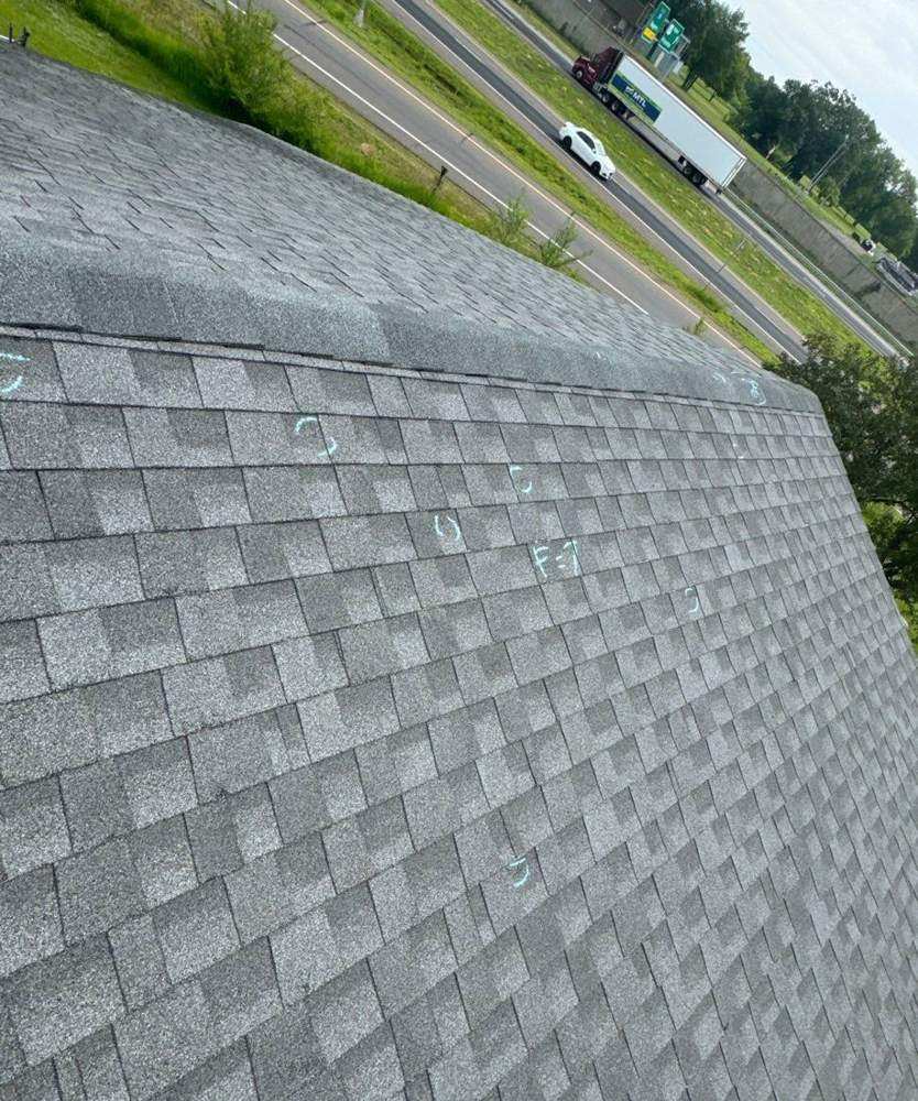 Shingle roof edge at Elk River Lodge & Suites overlooking Highway 10, June 2024