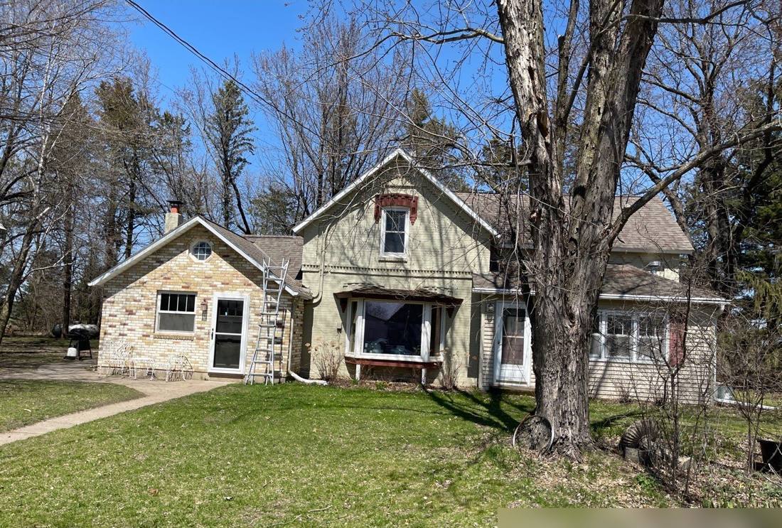 Farmhouse with a brick addition near Royalton, photographed during a roof inspection, May 2022