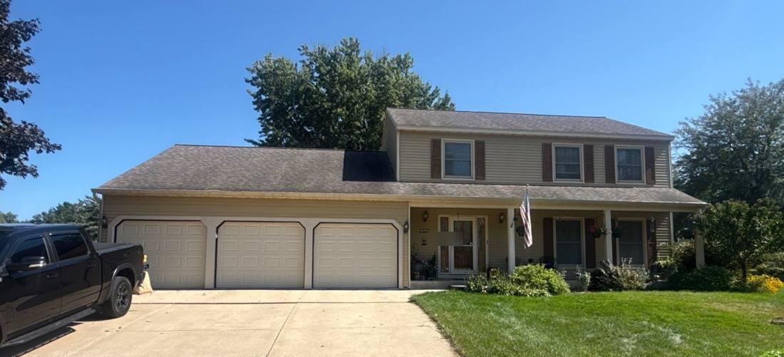 Two-story home in Rochester photographed during a roof inspection, September 2026