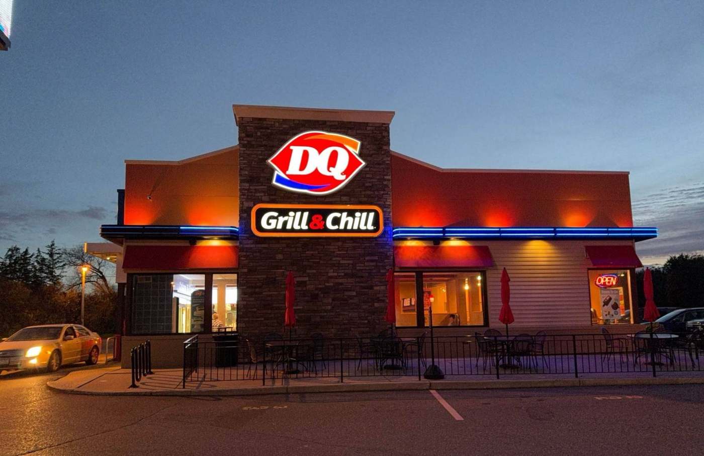 Dairy Queen Grill & Chill on Highway 12 in Delano, MN at dusk, a Repair King commercial roofing job photographed in October 2023