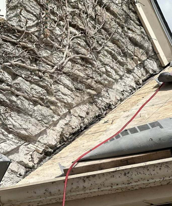 Underlayment and ice protection going in where the roof meets the stone wall, Richfield, April 2025