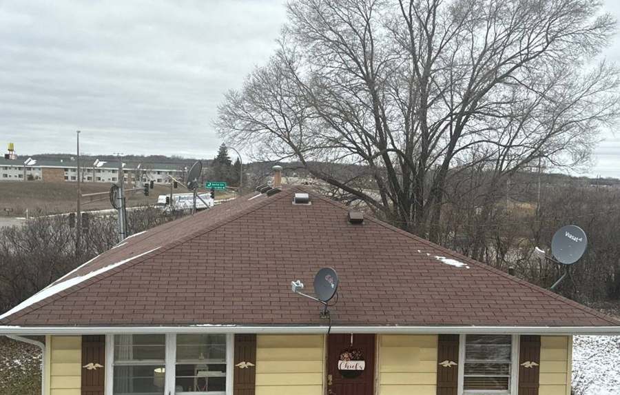 Yellow rambler with a brown hip roof in south Lakeville during a winter roof inspection, January 2024