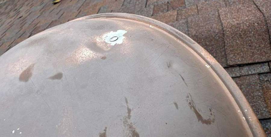 A dented metal roof vent cap on the Larson Court home in Shoreview, October 2023