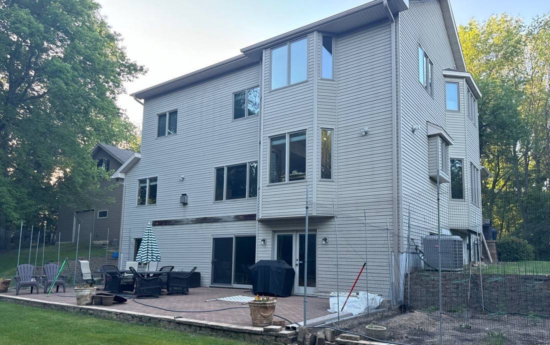 Rear elevation and patio of a modern three-story Oak Grove home, June 2024
