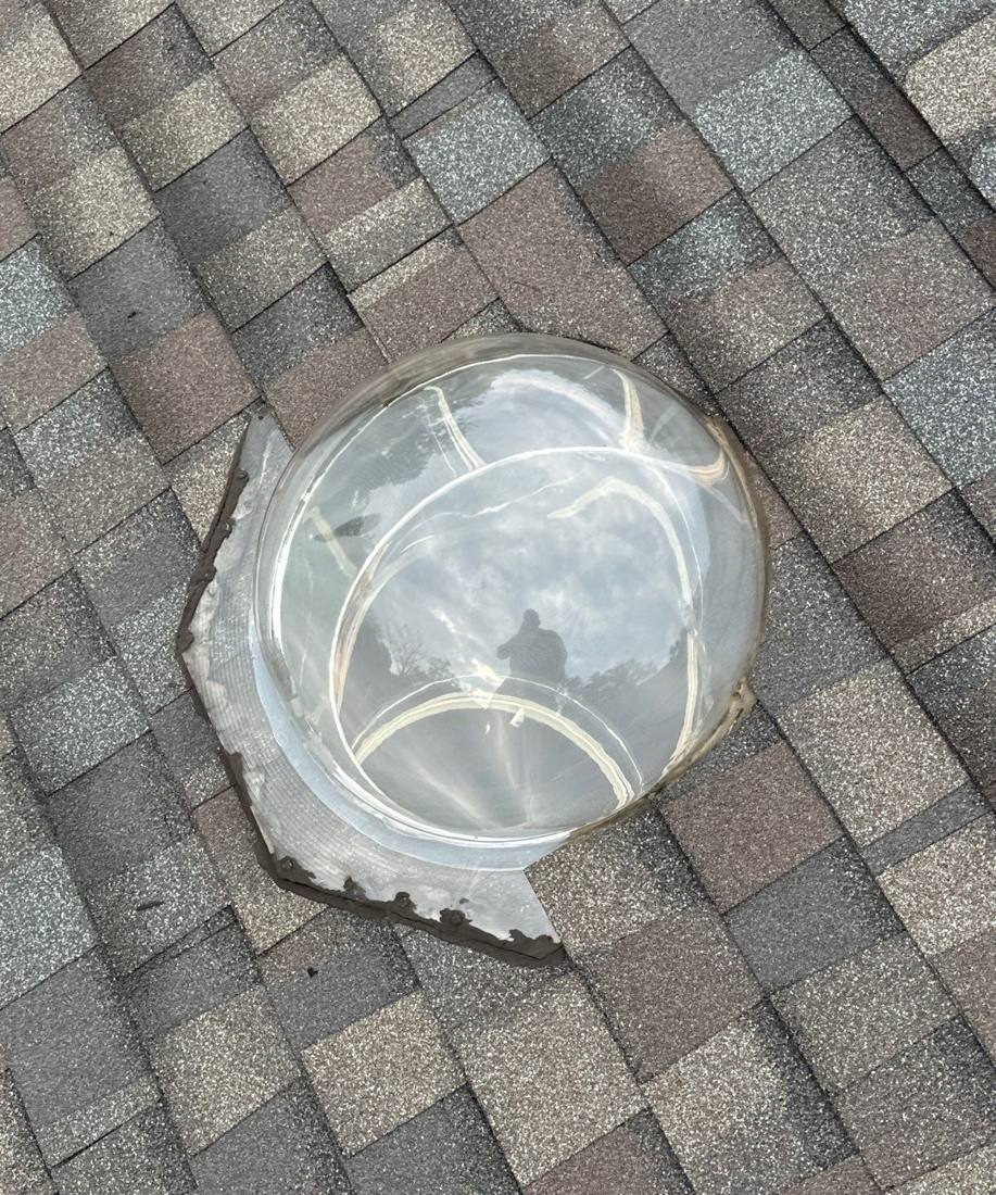 Plastic skylight dome with hairline cracking, found during a Clearwater roof inspection, July 2024