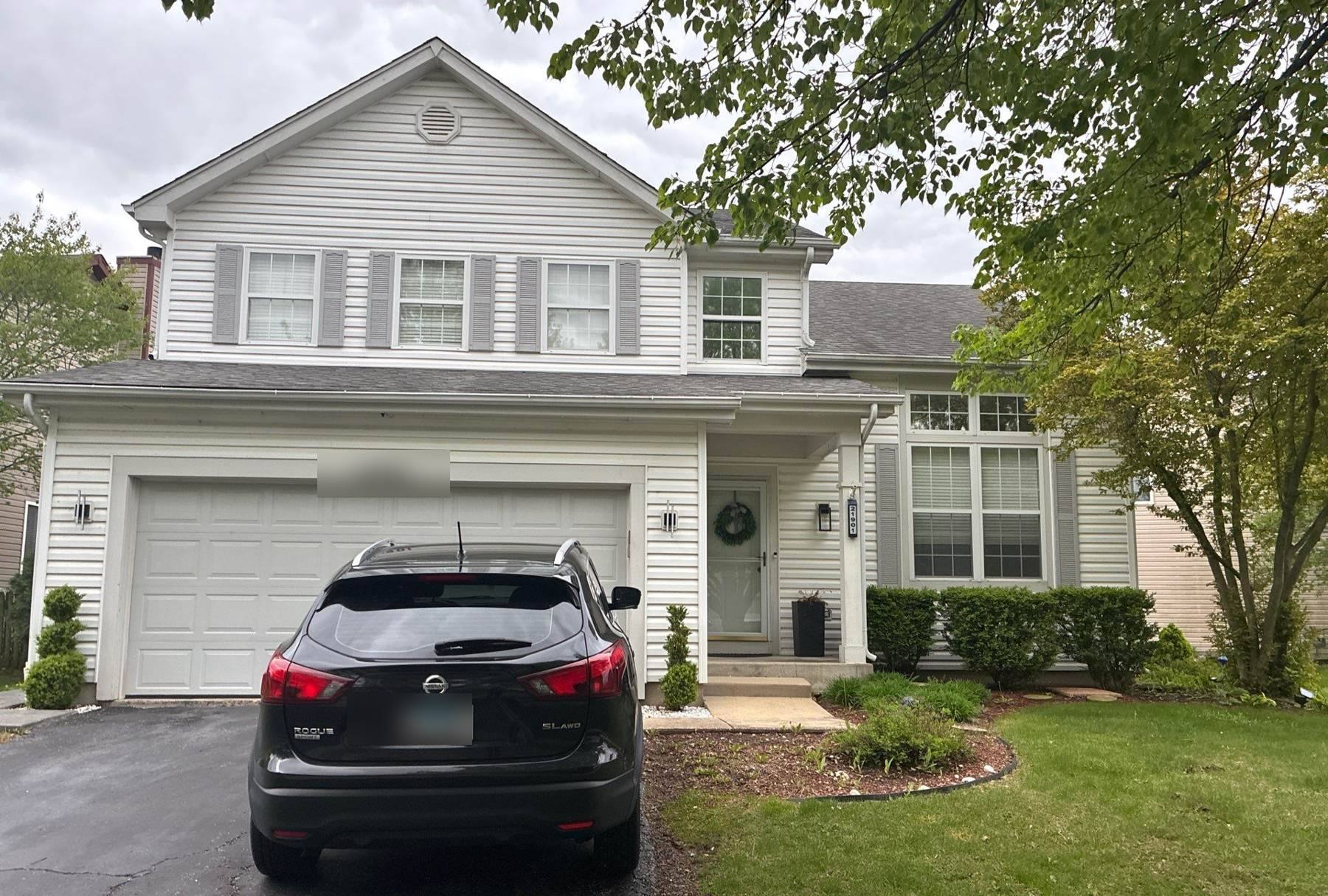 Two-story home in a Plainfield, IL subdivision photographed by Repair King during an April 2026 roof project