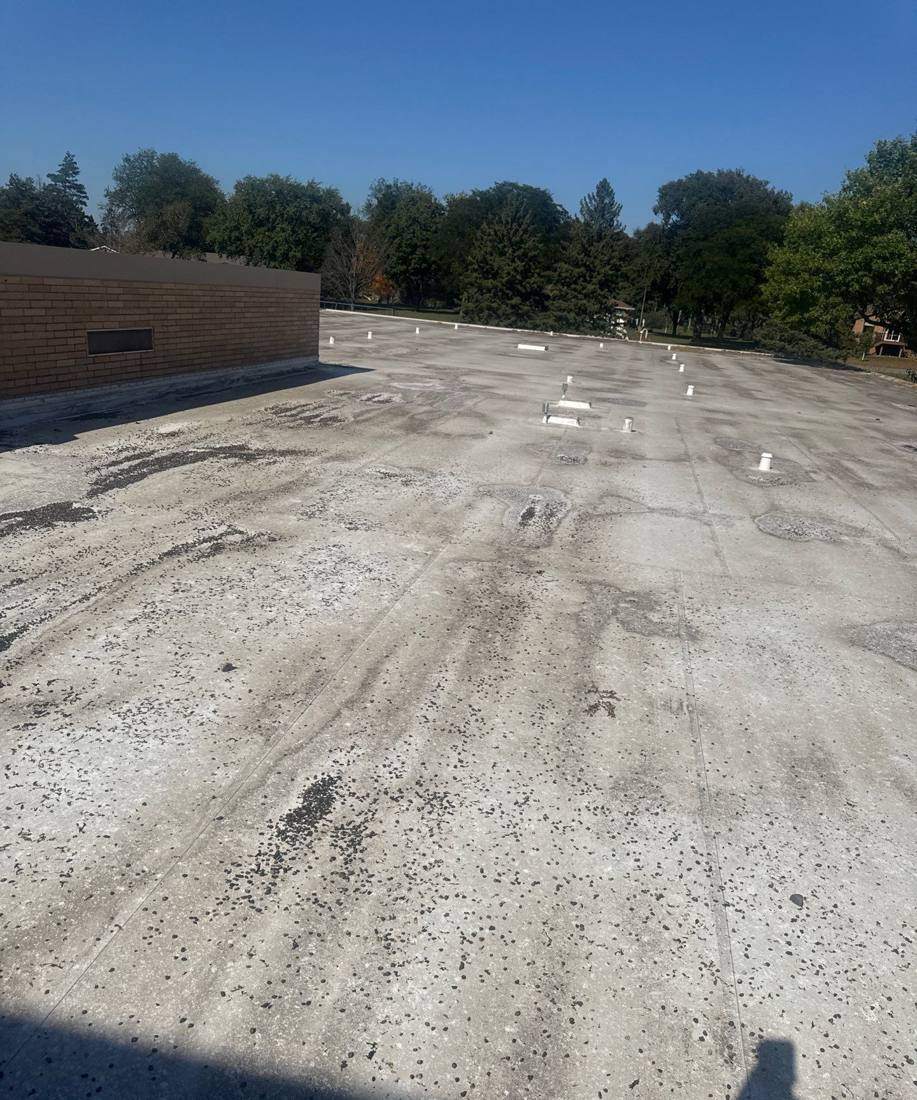 Low-slope roof and brick parapet wall at Minnetonka Christian Academy, inspected by Repair King in September 2025