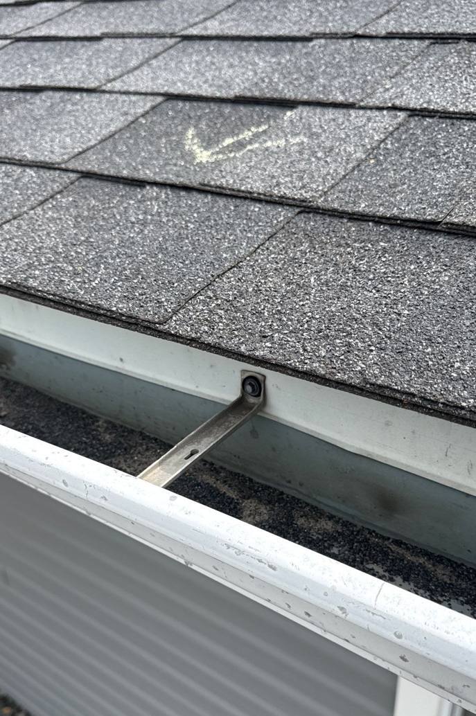 Chalk-marked shingle above the white gutter and blue siding at Valley View Assembly of God in Lake City, MN, April 2026