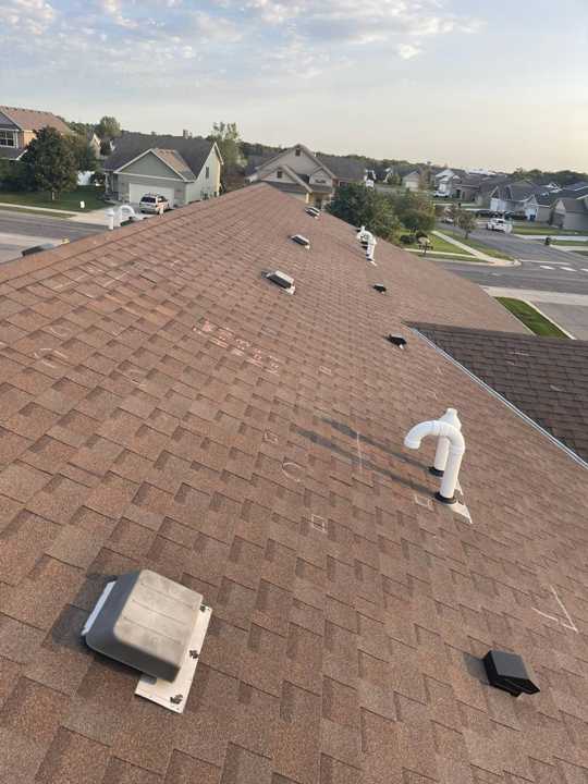 View across a Pinecone Villas townhome roof toward the neighboring buildings in Sartell, September 2021