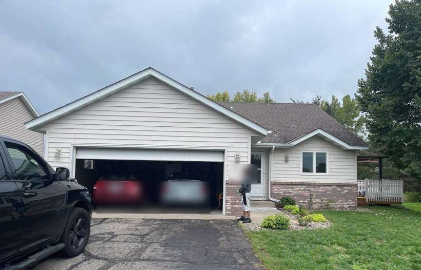 Front of a Sauk Rapids home during a Repair King exterior inspection, October 2021 (vehicles and house number blurred)