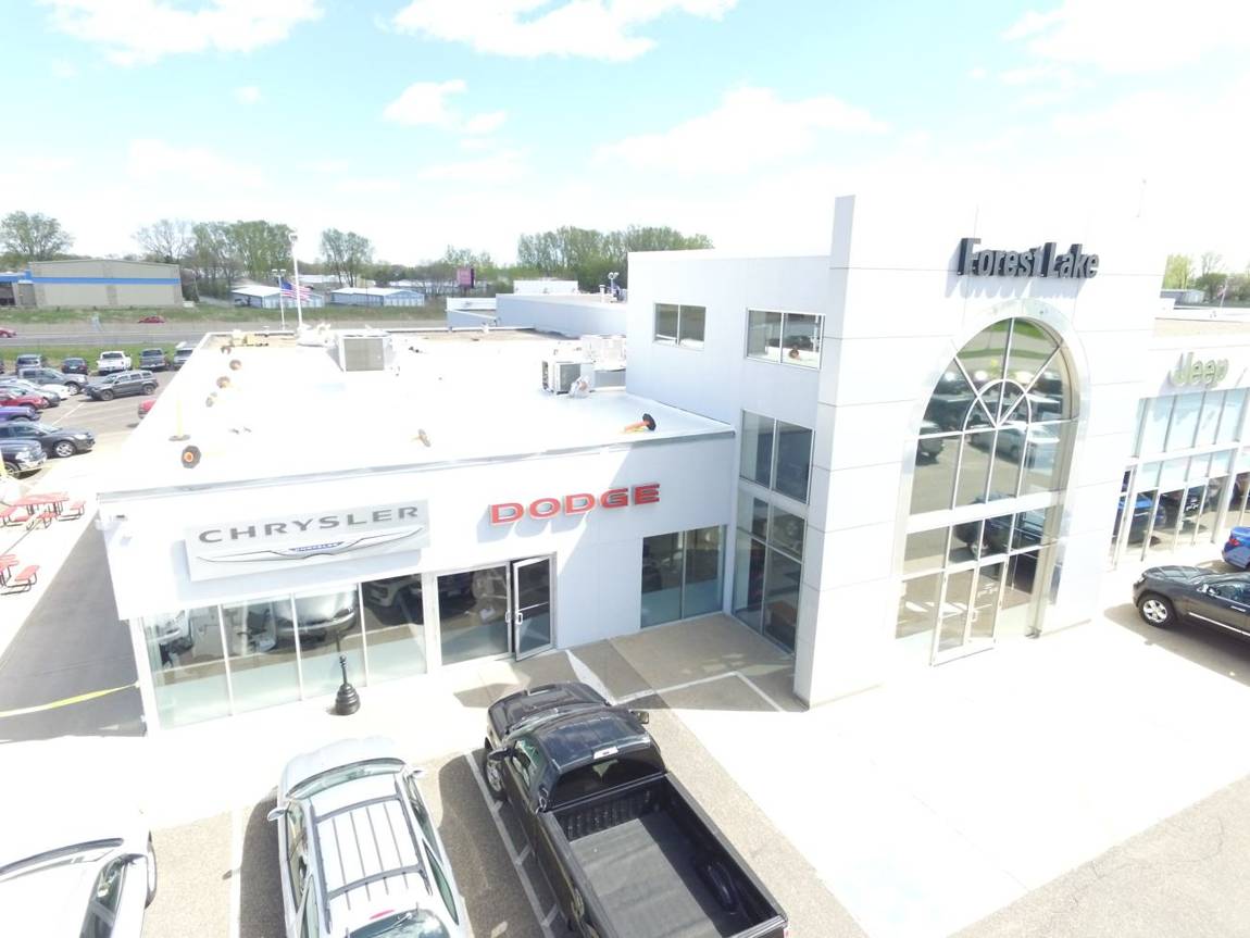 Aerial photo of Forest Lake Chrysler Jeep Dodge in Forest Lake, MN, showing the Chrysler and Dodge storefront and the new white Duro-Last roof above it