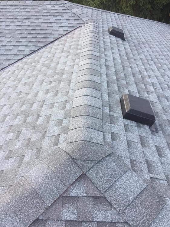 Evenly spaced hip and ridge cap shingles with roof vents on a new Repair King roof