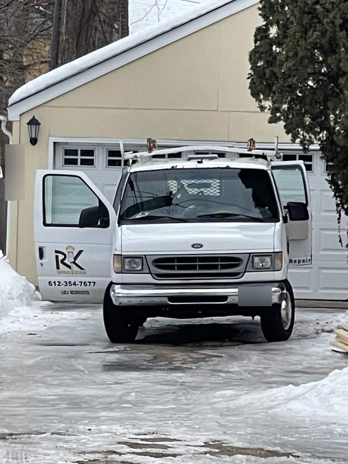 Repair King work van parked in a snowy driveway at an ice dam job