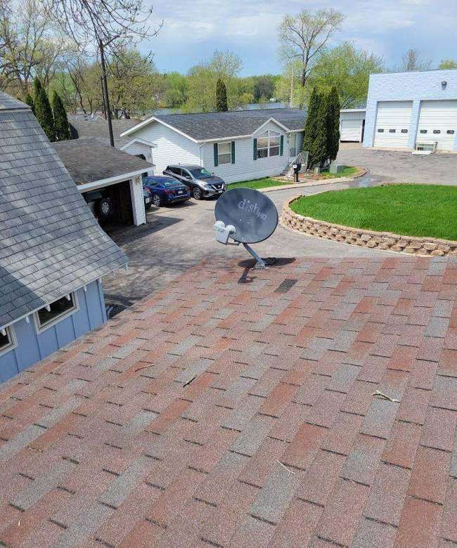 Aerial view of a manufactured-home roof and street in Landfall, May 2022