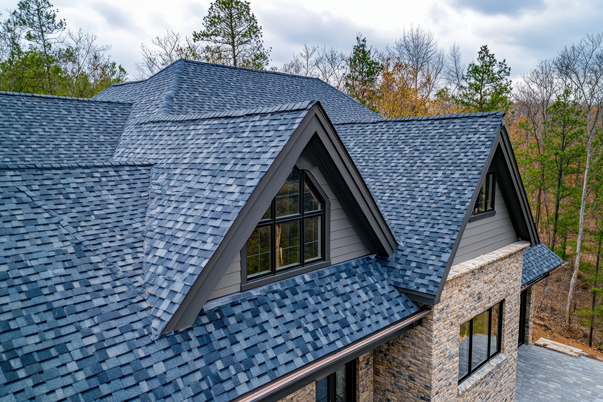 Architectural asphalt shingle roof installed on a stone home by Galaxy Roofing