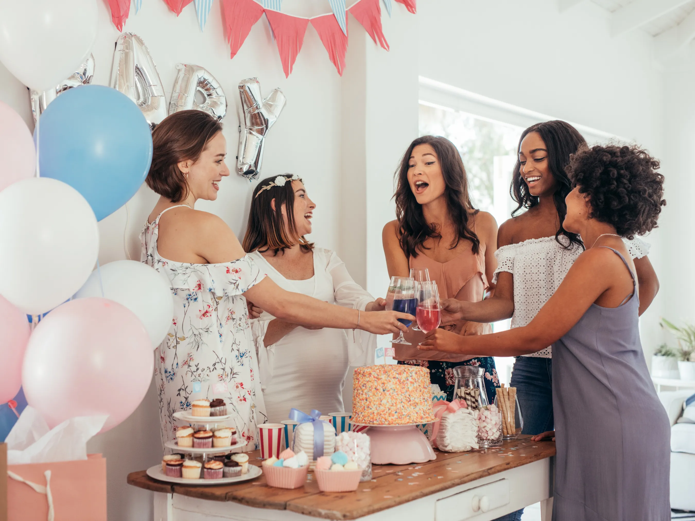 a group of women laughing at a baby shower