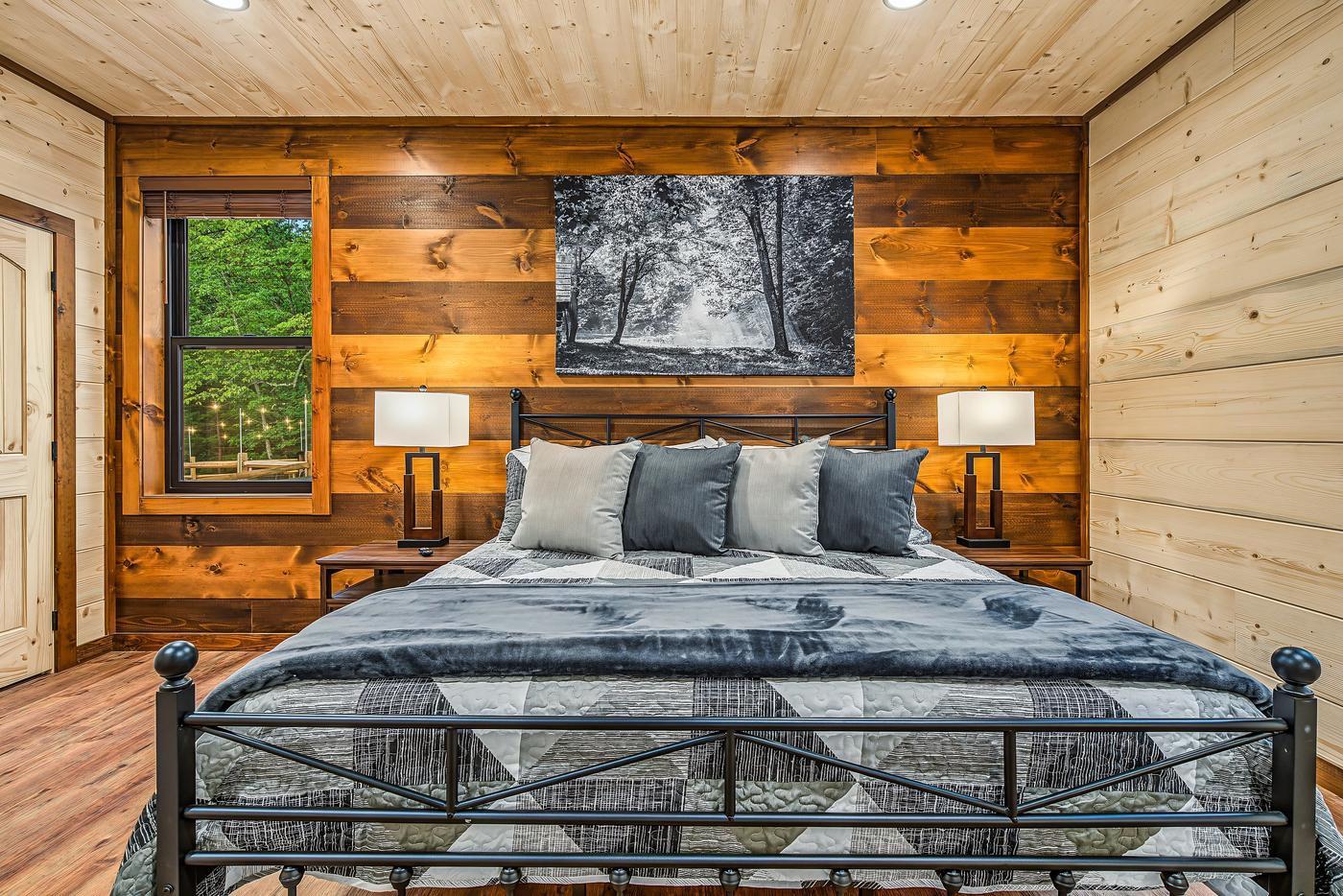 Main Level King Suite - king bed, dark wood accent wall