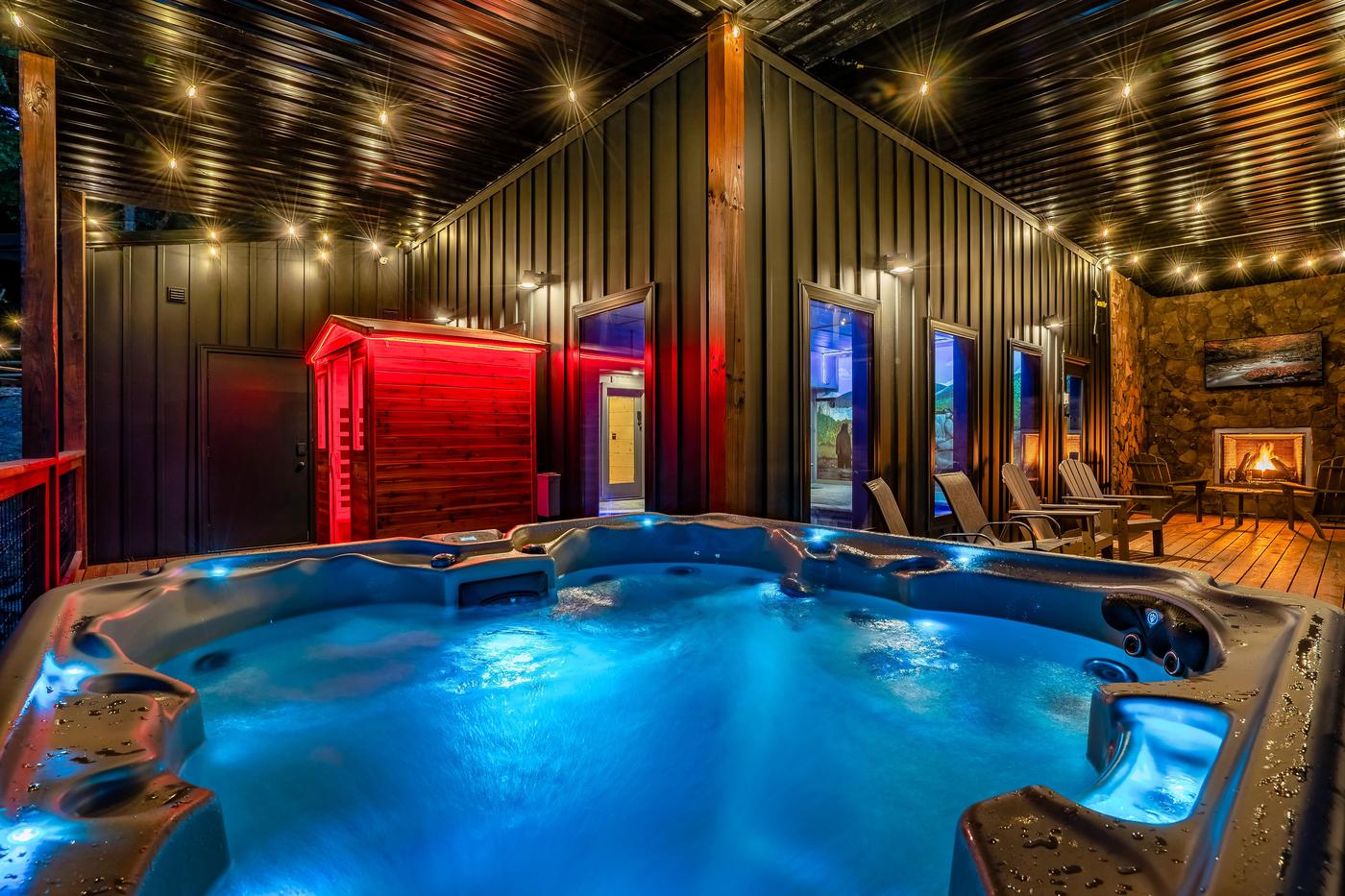 Hot tub, red light sauna, and outdoor gas fireplace on lower level
