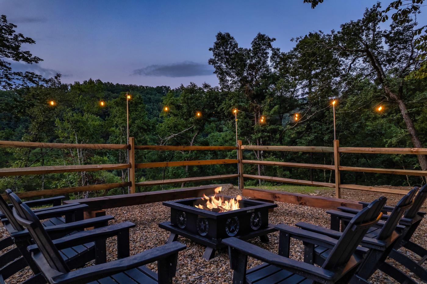 Fire pit terrace with Adirondack seating and wooded valley views