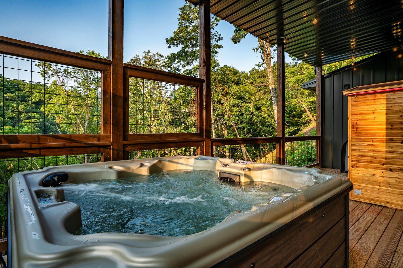 Lower deck — hot tub and sauna pod with blue ambient lighting