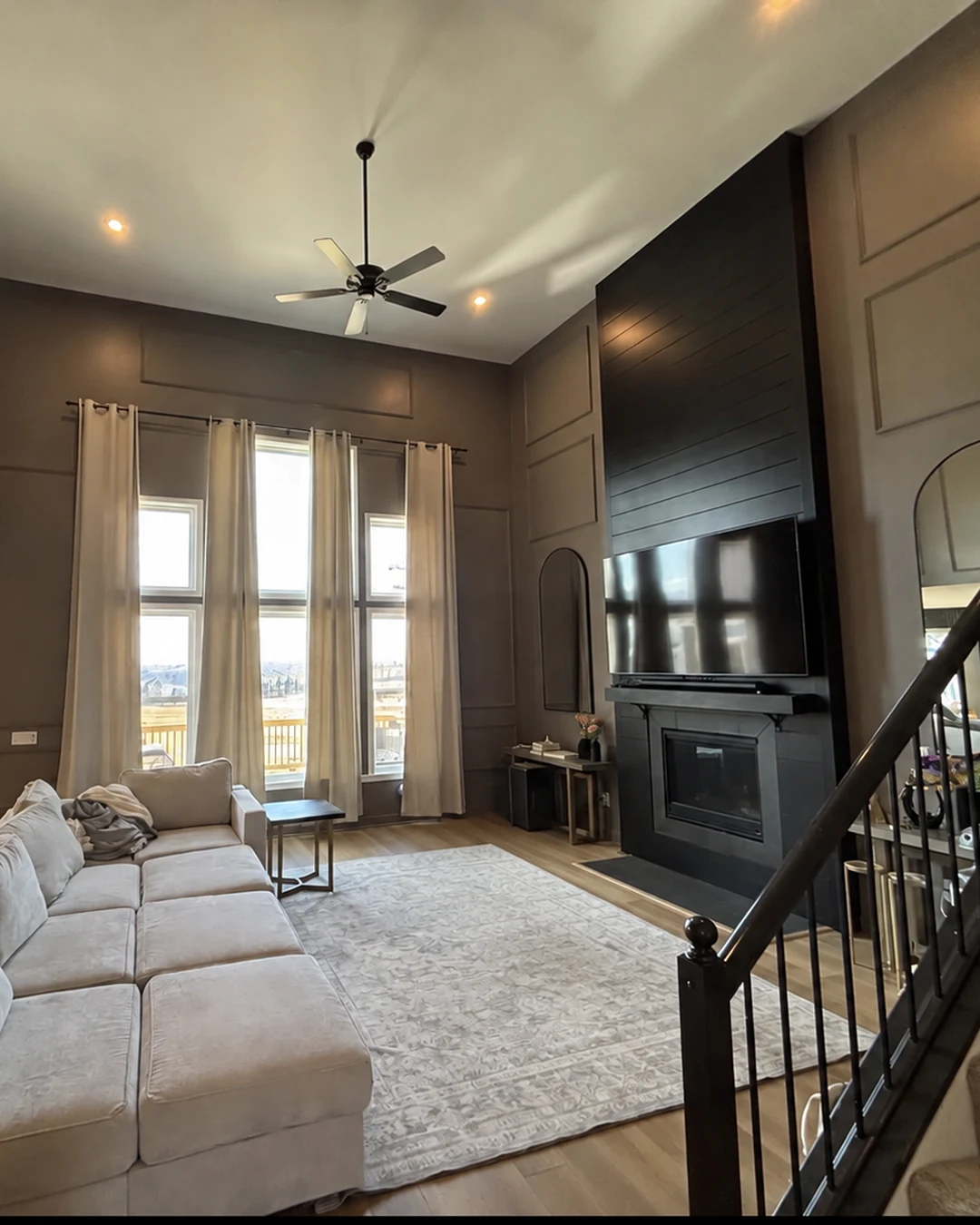 Quality Painters finished interior with paneled walls, windows and fireplace