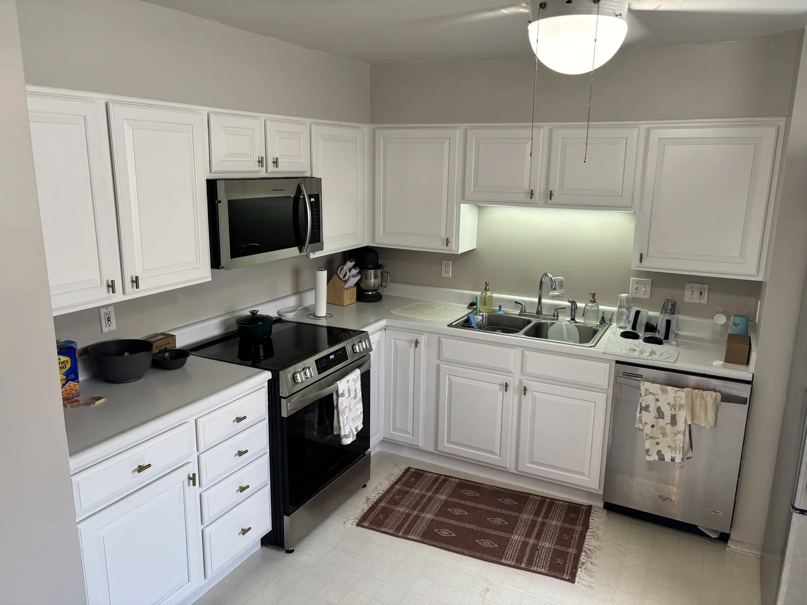 Completed cabinet painting project with refreshed kitchen cabinetry, island, and trim in Greater Cincinnati and Northern Kentucky
