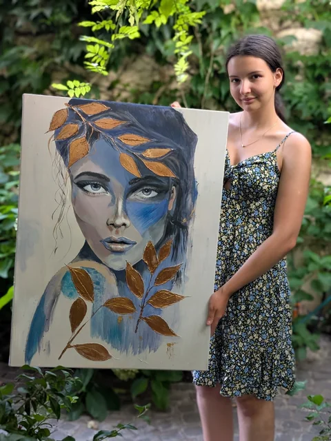 Fată la masterclass cu un portret cu frunze aurii
