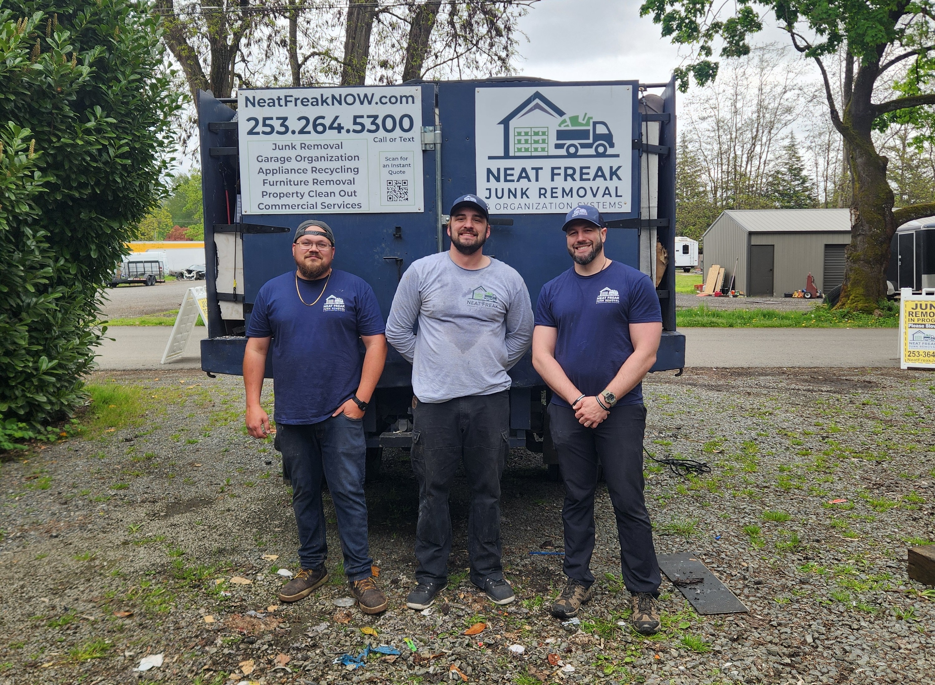 The Neat Freak team standing in front of their branded junk removal truck