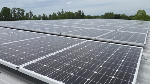 Advantage Roofing crew integrating solar panels with a newly finished roof