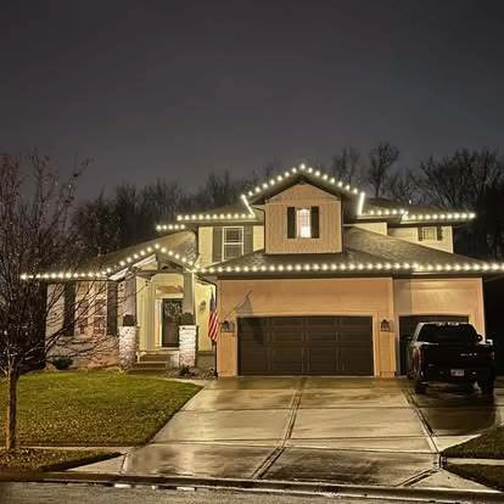 Warm white and red C9 bulbs tracing every peak of a two-story home