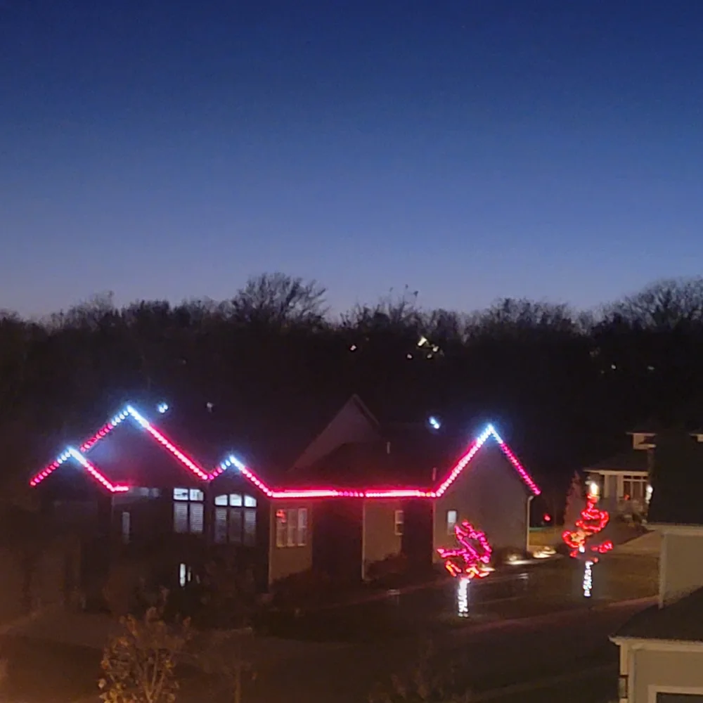 Classic multicolor C9 bulbs on a two-story home at night
