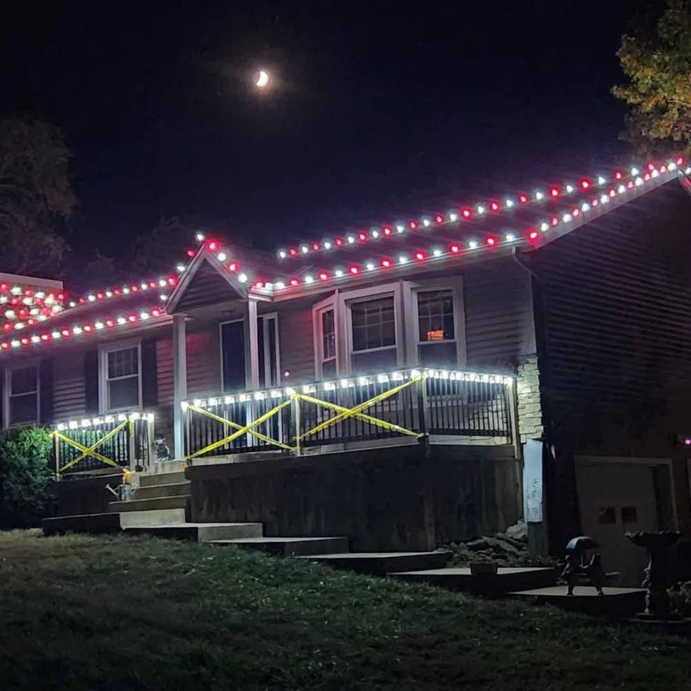 Cool white C9 bulbs tracing the roofline of a brick home