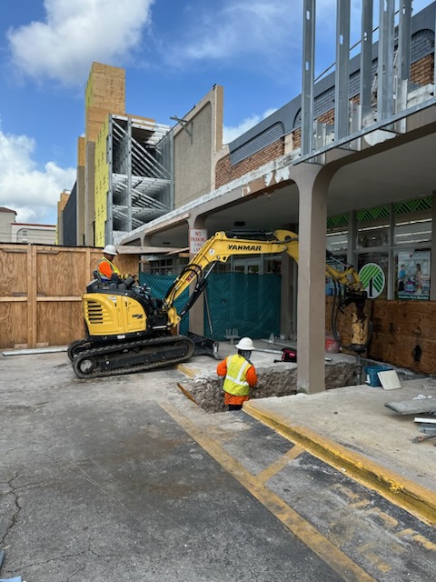 SCFS crew and compact equipment working near a commercial building column