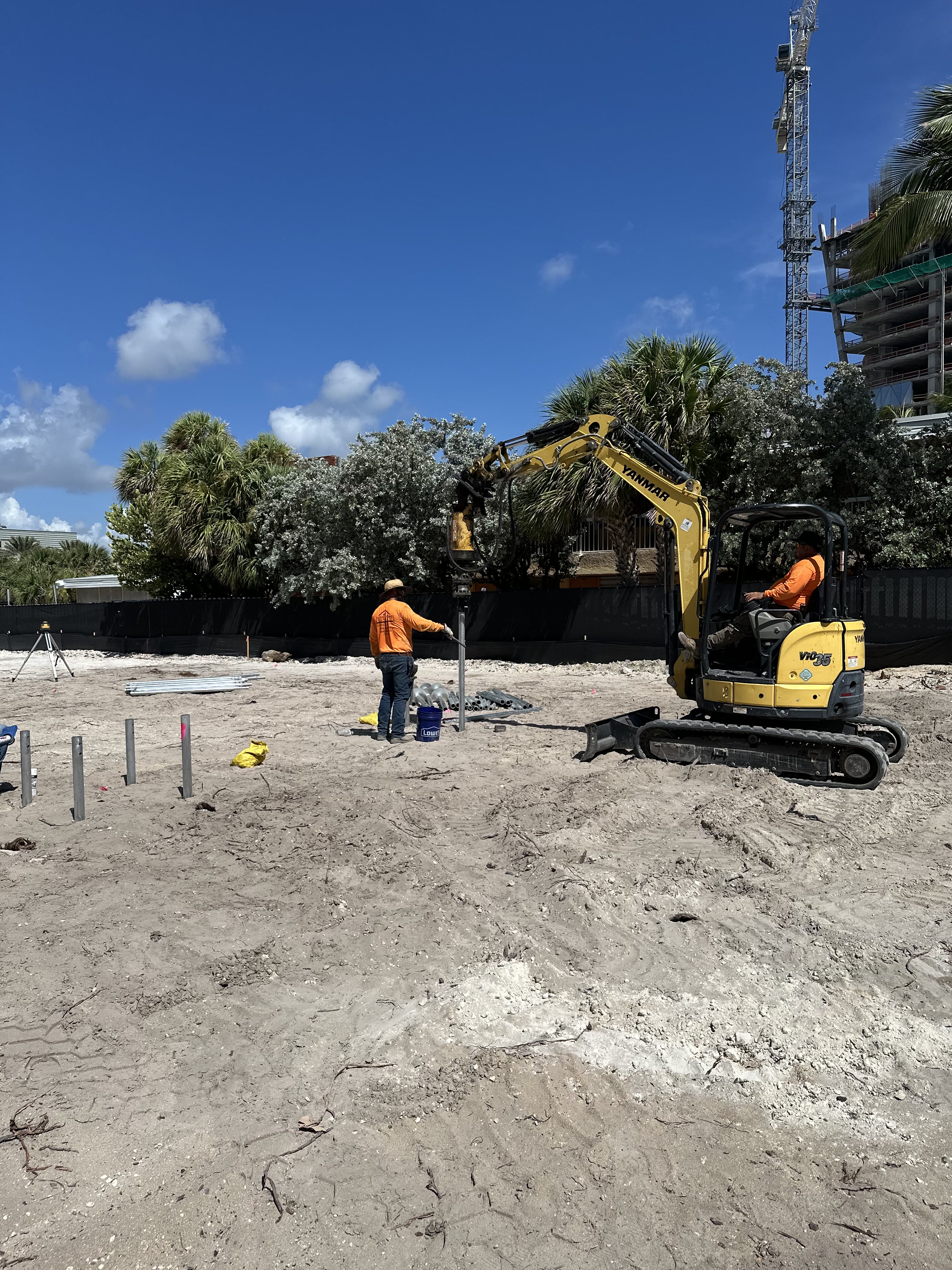 SCFS crew using compact equipment to install piles at a South Florida commercial construction site