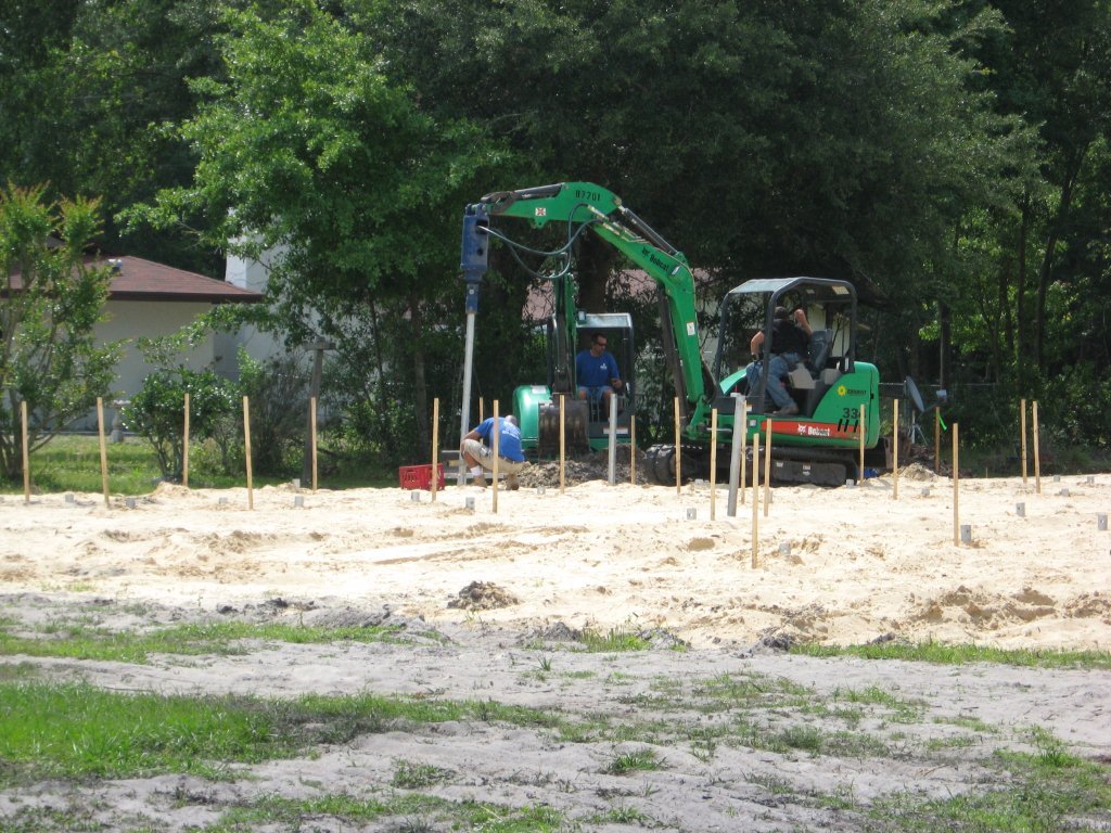 Pile layout and compact equipment on an open South Florida residential construction lot