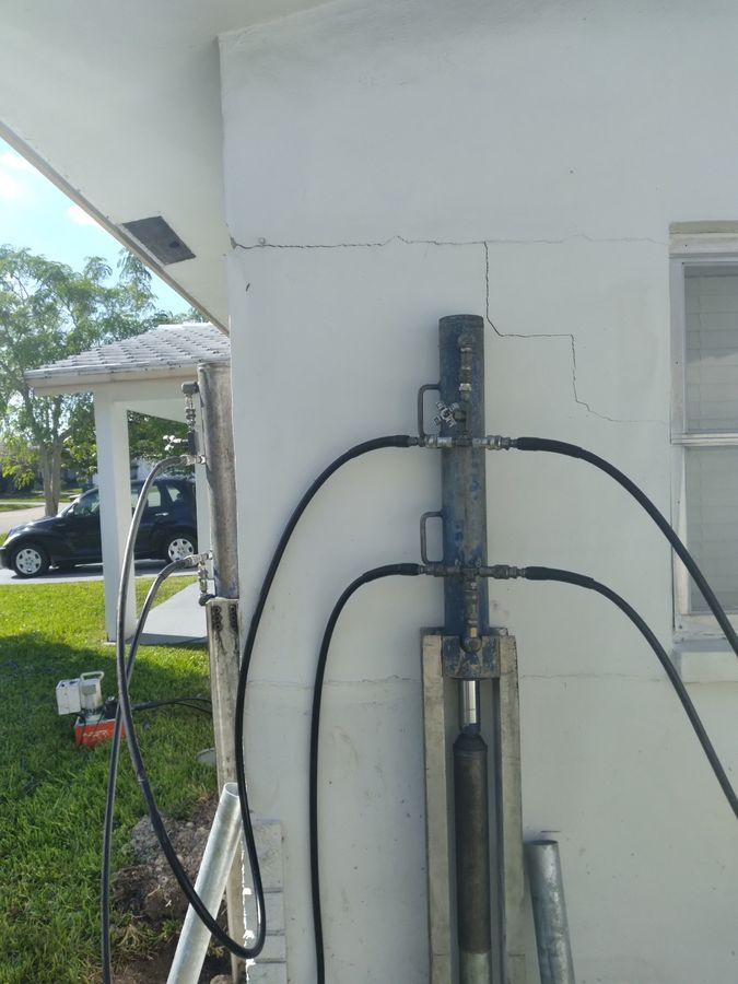After: the same house corner, with the crack visibly tighter