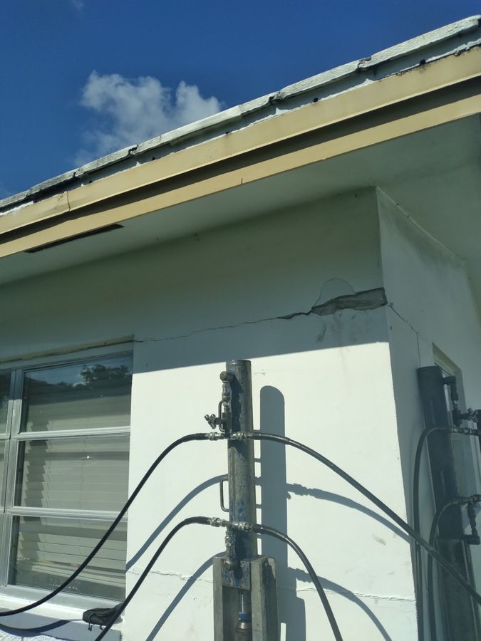 After: the same corner with a pier bracket installed and the crack sealed