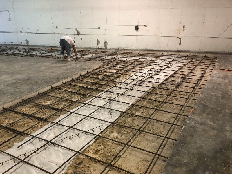 SCFS crew member working the rebar mat during an interior slab rebuild