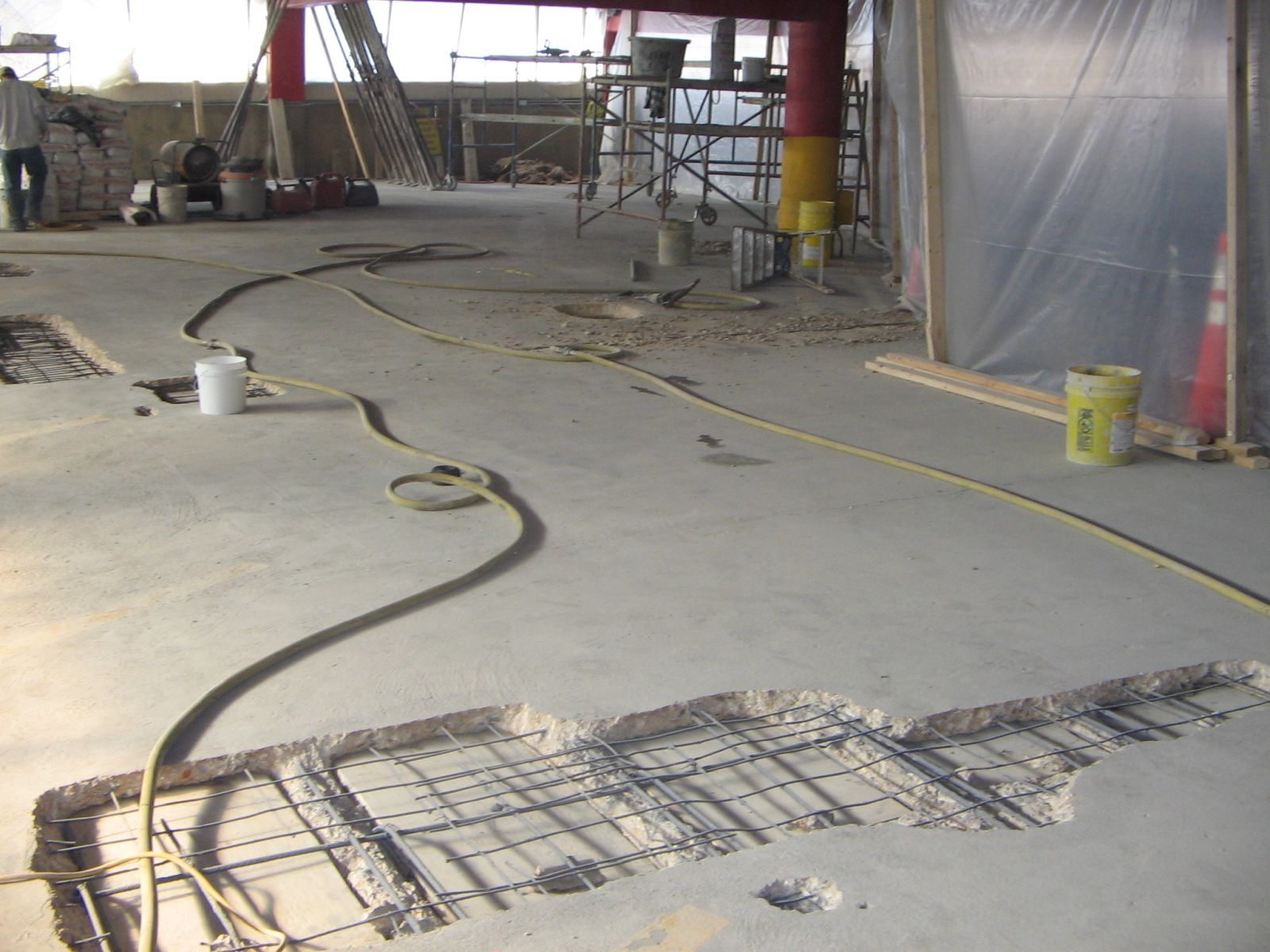 Interior concrete slab opened for repair with reinforcement exposed