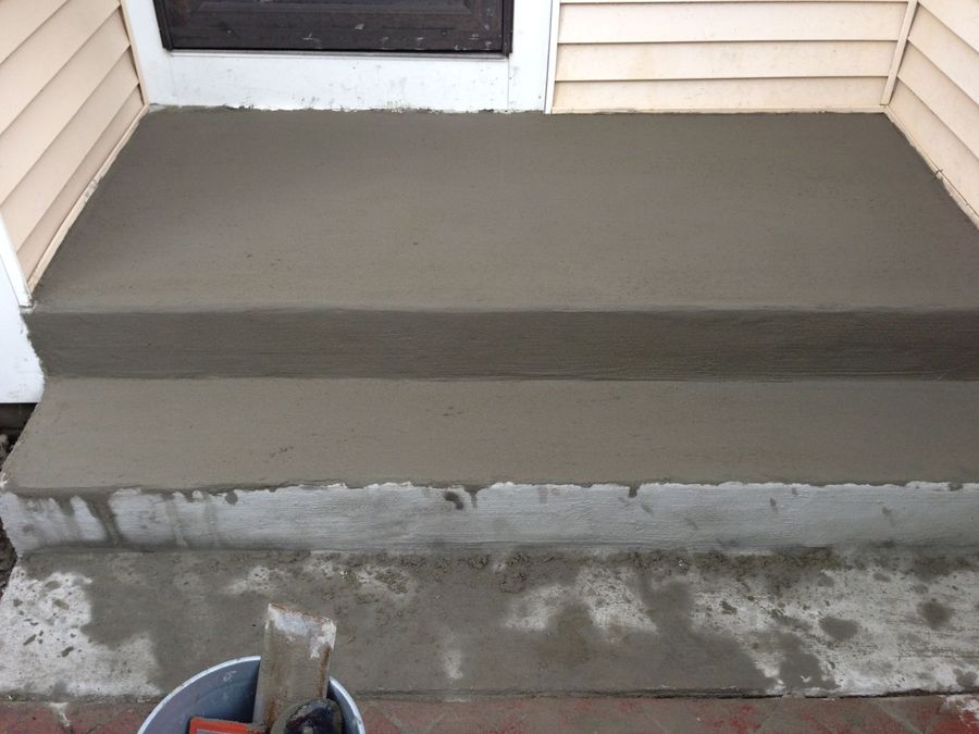 Rebuilt concrete entry steps with a smooth finish