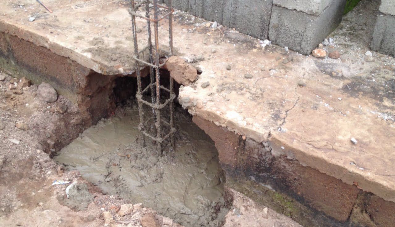 Excavated footing at a brick foundation exposed during project work