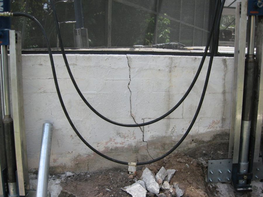 Foundation support piers installed on either side of a cracked stem wall