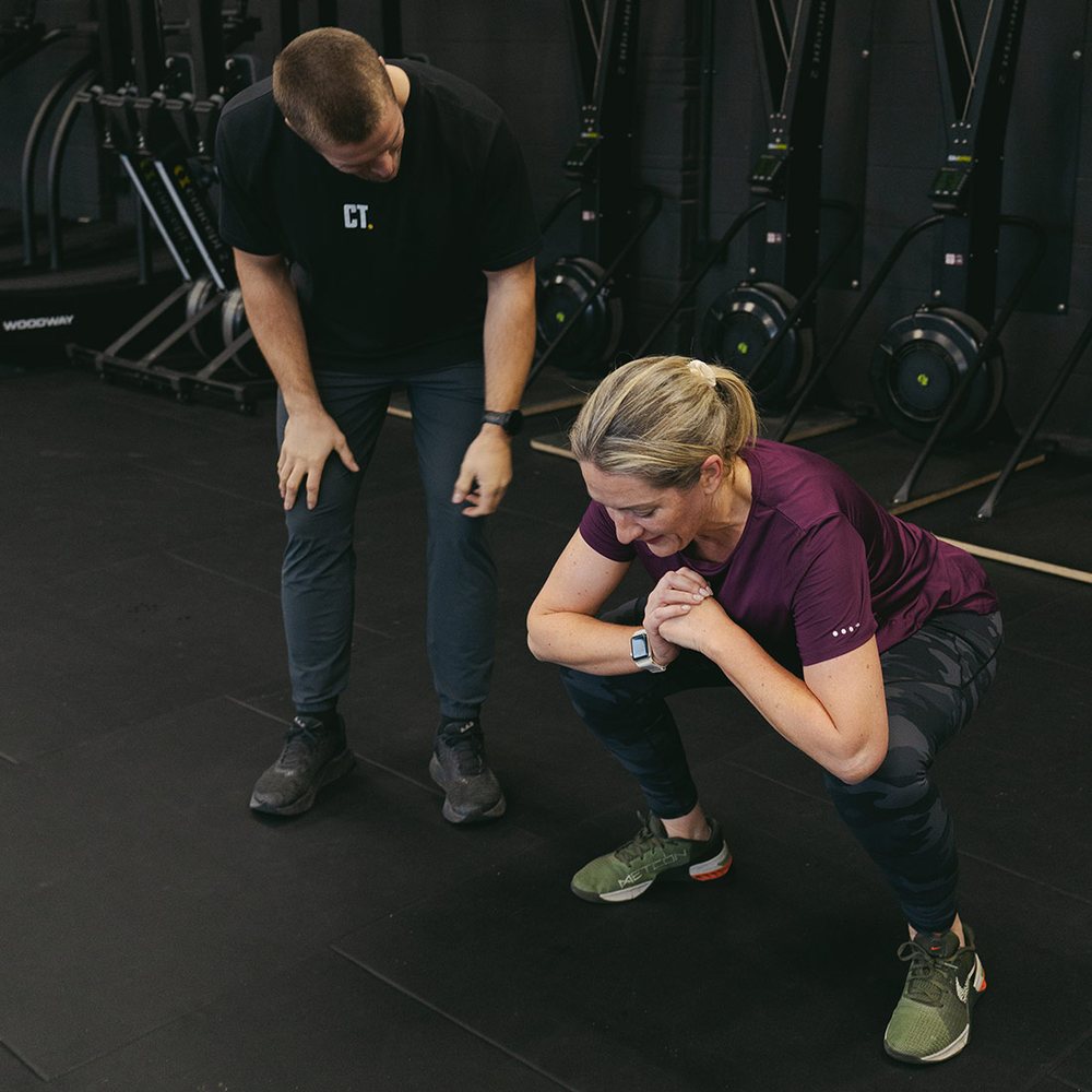 A coach cueing a member through a lift