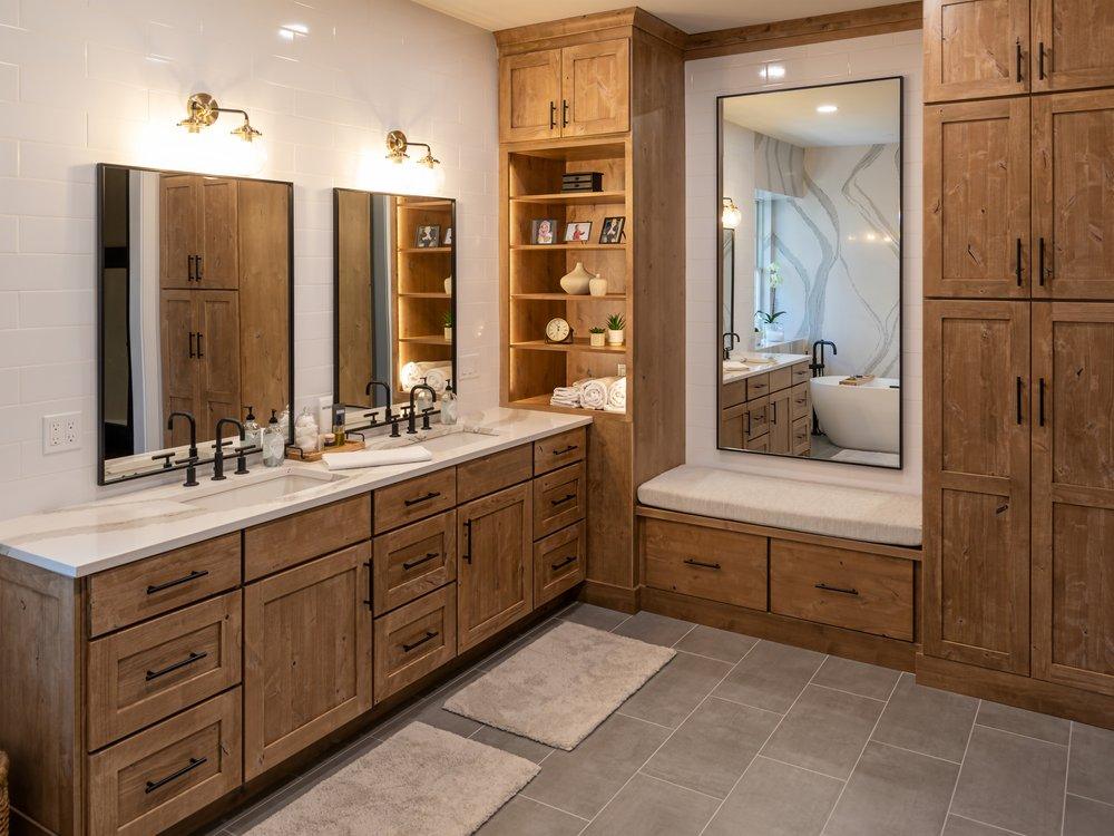 Double vanity with a full stone wall
