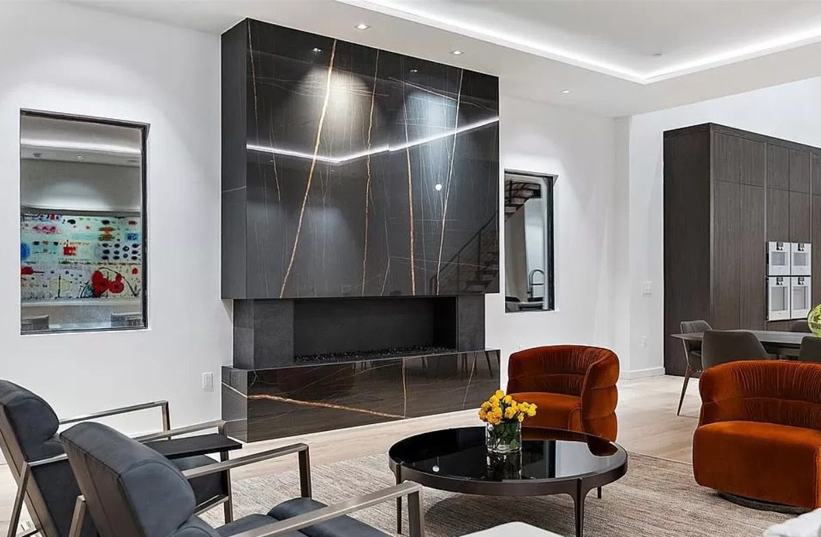 Living room with a dark stone fireplace surround