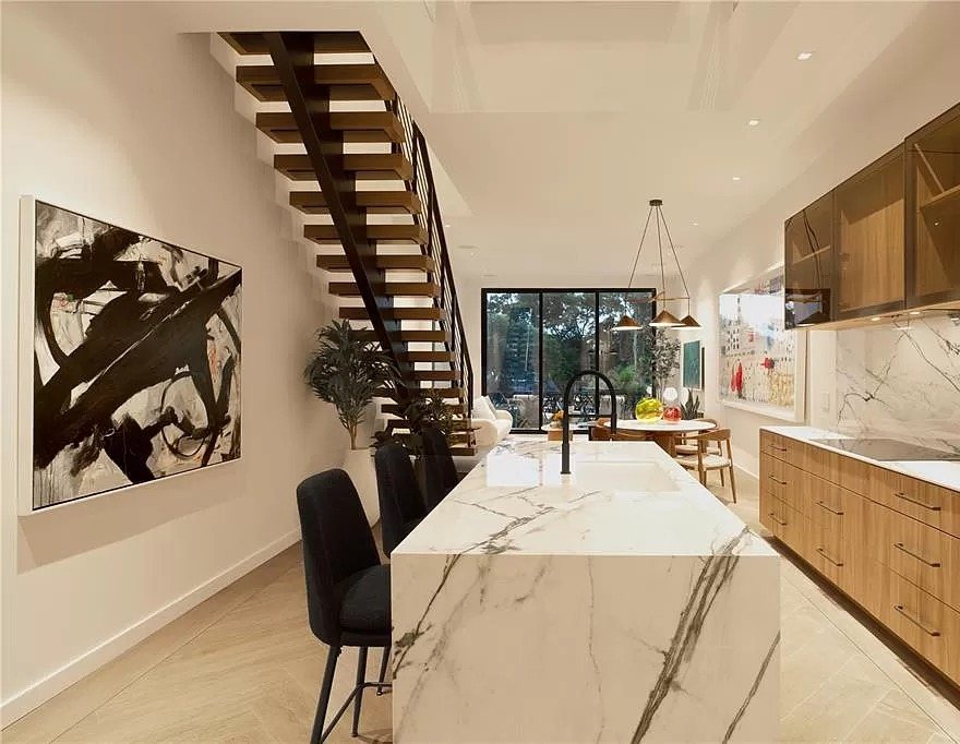 Kitchen with a long stone waterfall island