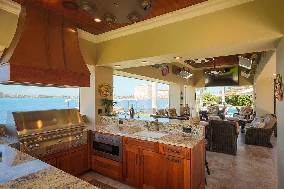 Outdoor kitchen with granite countertops by the water