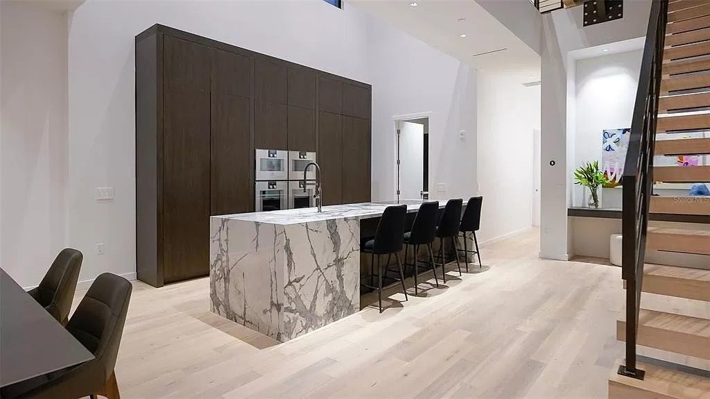 Modern kitchen with a veined stone waterfall island