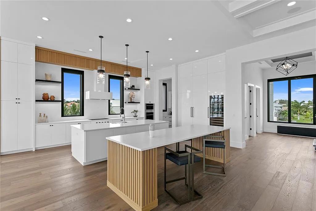 Bright kitchen with stone island and large windows
